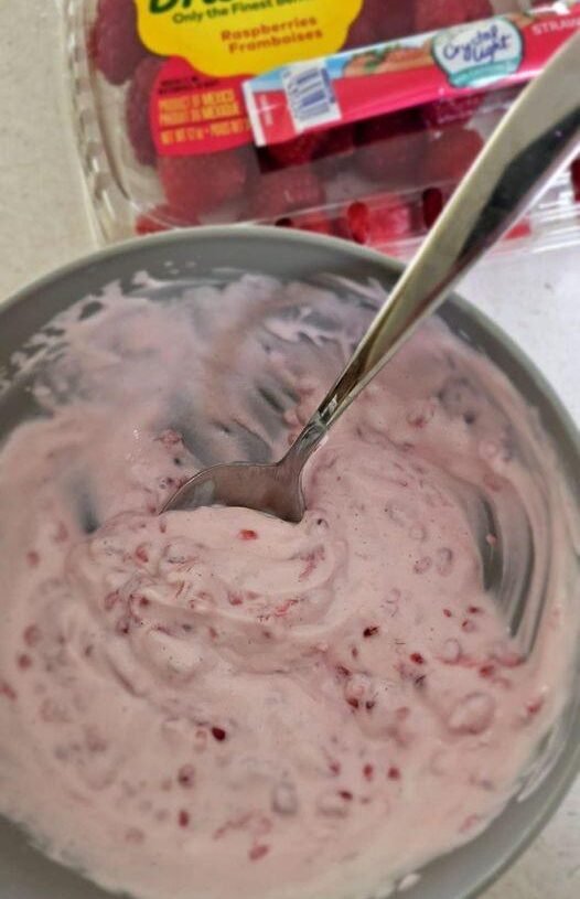 Greek yogurt with mashed raspberries
